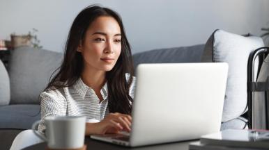 Consultant accessing cybersecurity training via laptop at home