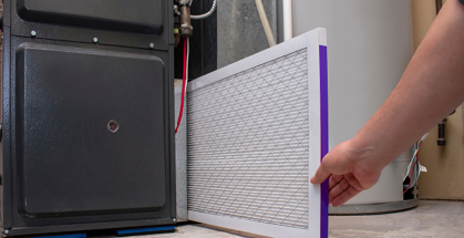 Person changing filter of furnace