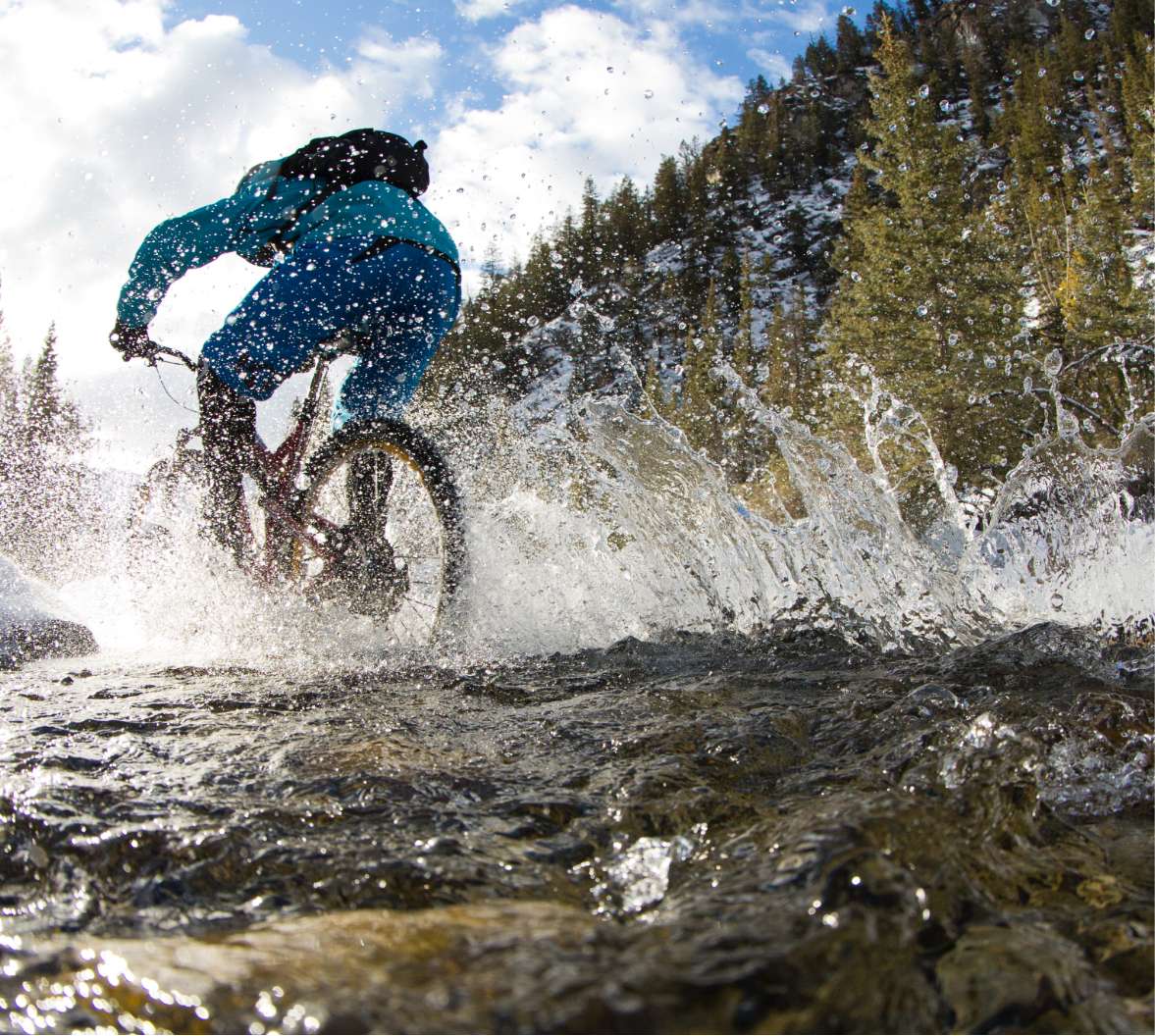 Mountain biker splashing in stream