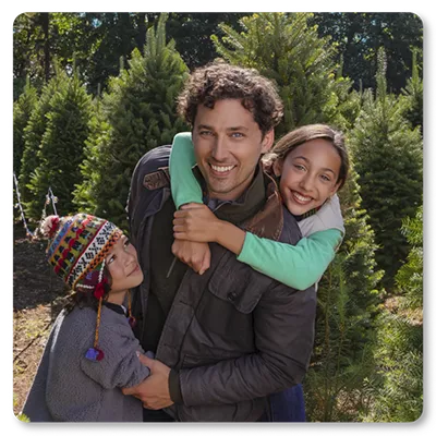 smiling man with two kids